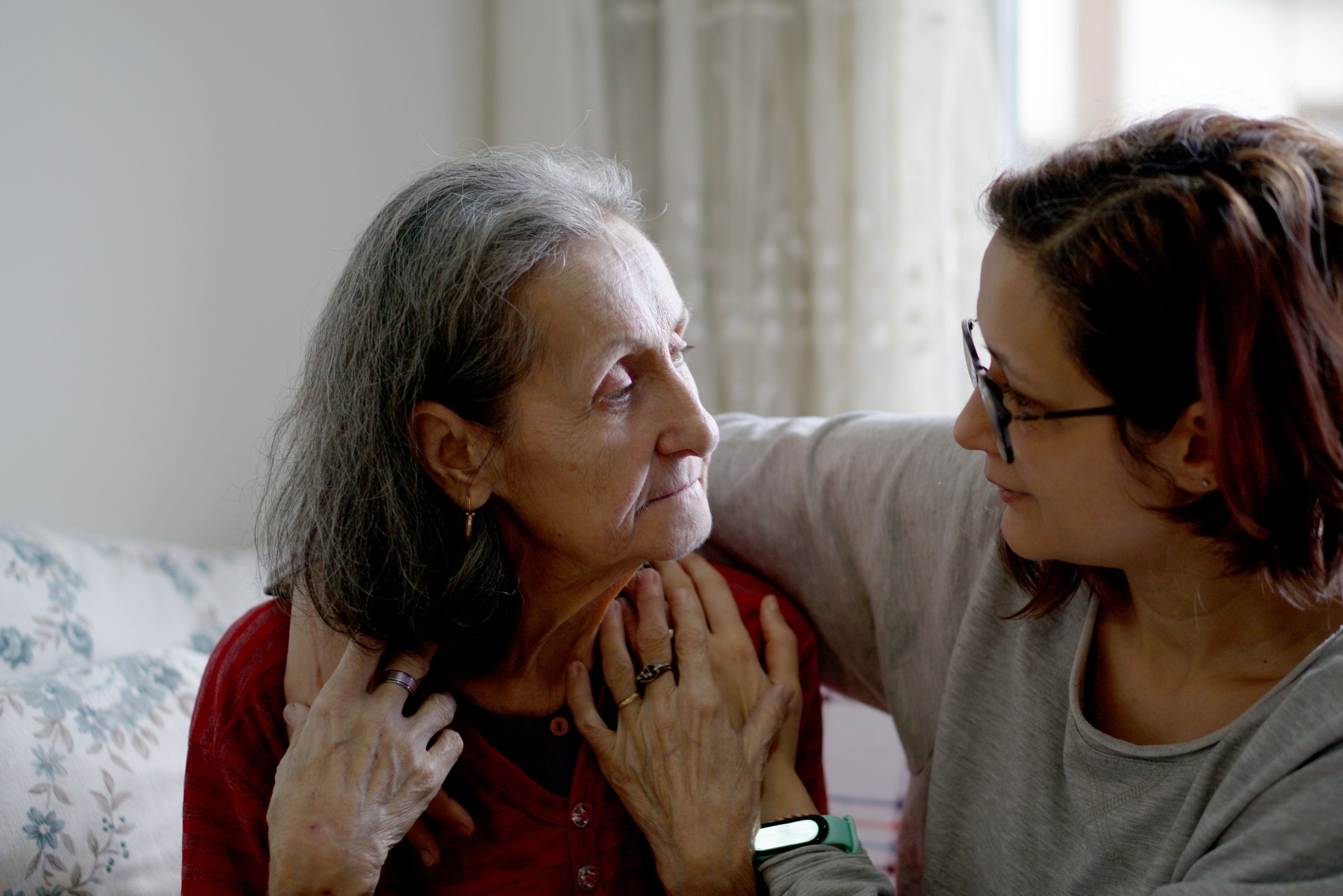 Woman hugging her elderly mother